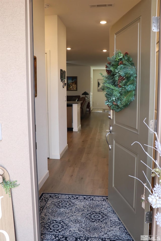 hallway with dark hardwood / wood-style floors