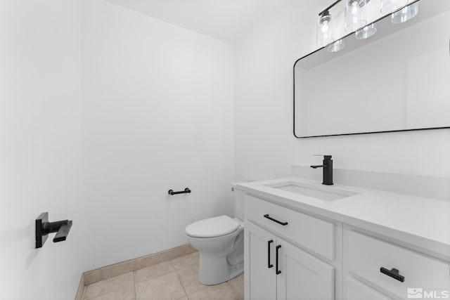 bathroom featuring tile patterned flooring, vanity, and toilet