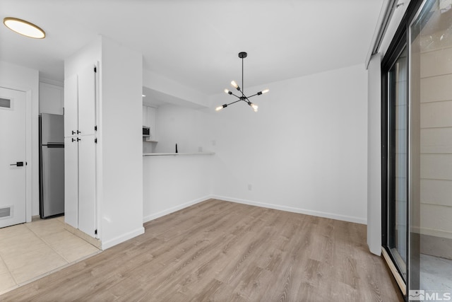 interior space with light wood-type flooring and a notable chandelier