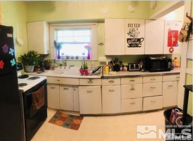 kitchen featuring white cabinetry and black appliances