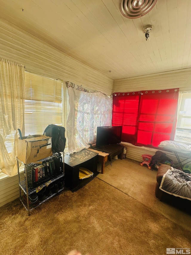 carpeted living room with wood ceiling