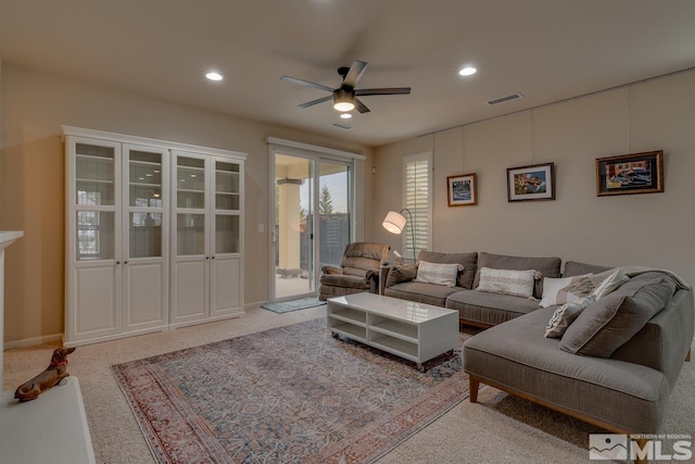 living room with ceiling fan and carpet floors