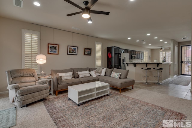 living room featuring ceiling fan and light colored carpet