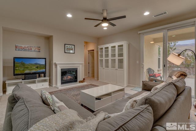 living room featuring ceiling fan and light colored carpet