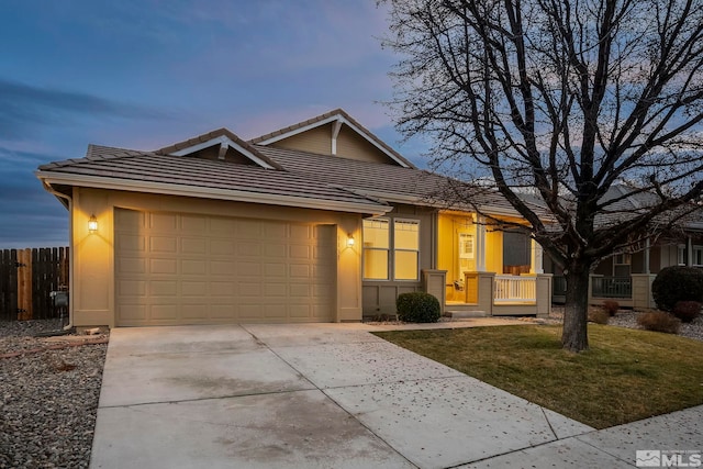 ranch-style home with a lawn and a garage