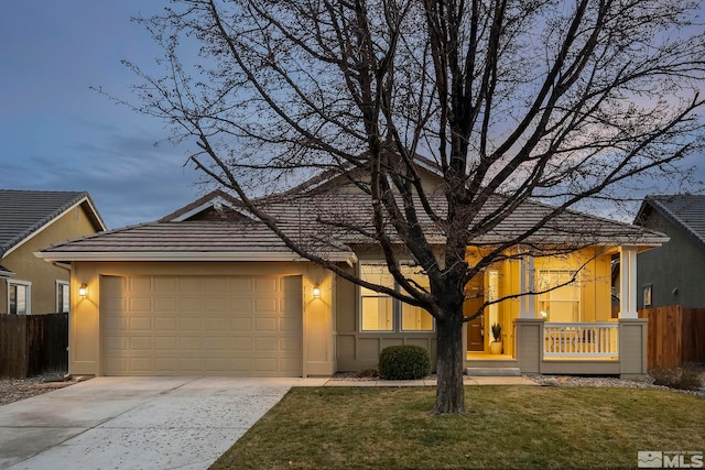 view of front of property with a garage and a lawn