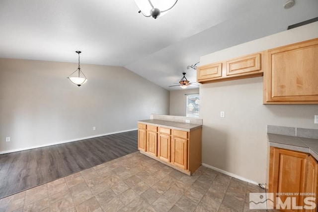 kitchen with pendant lighting, light brown cabinets, ceiling fan, and lofted ceiling