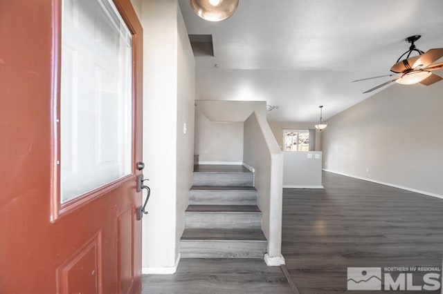 stairway featuring hardwood / wood-style flooring, ceiling fan, and lofted ceiling