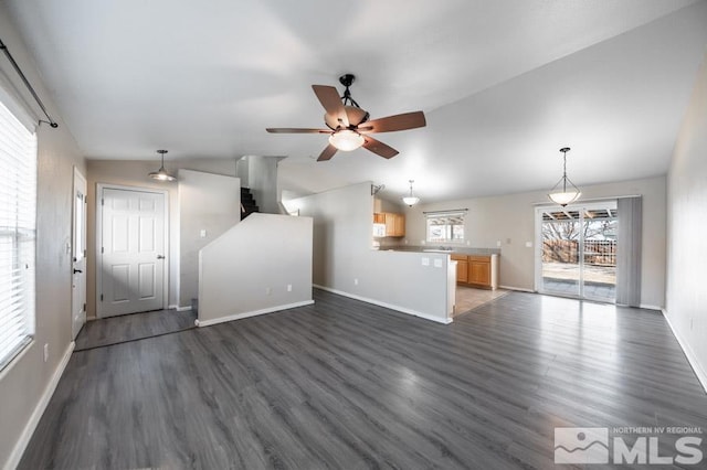 unfurnished living room with ceiling fan, dark hardwood / wood-style floors, and lofted ceiling