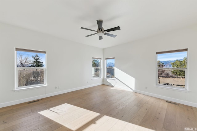 unfurnished room featuring ceiling fan and light wood-type flooring