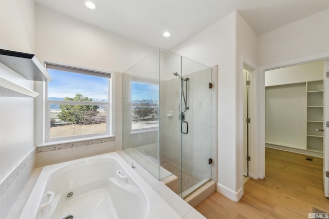 bathroom with plus walk in shower and wood-type flooring