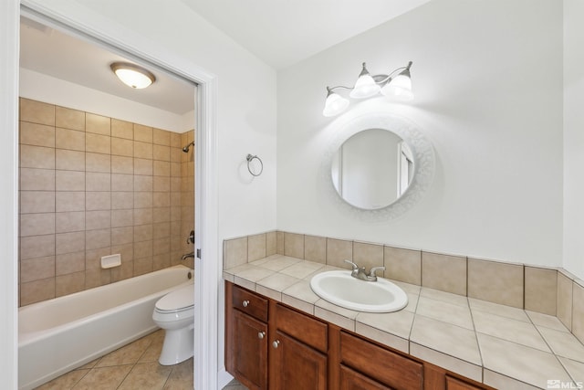 full bathroom with tile patterned flooring, vanity, toilet, and tiled shower / bath