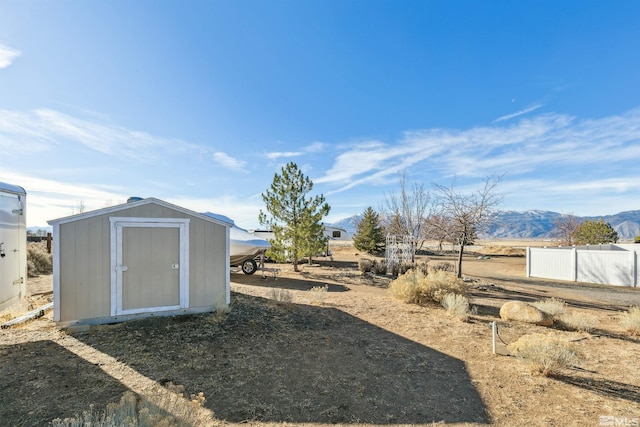 view of yard with a mountain view and a storage unit