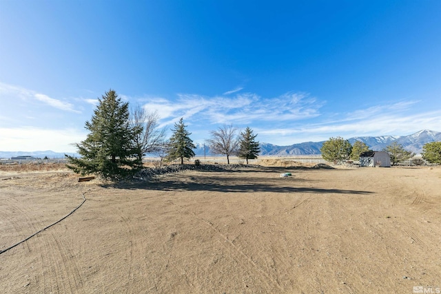 view of yard featuring a mountain view and a rural view