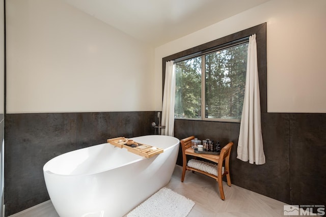 bathroom featuring a washtub and parquet floors