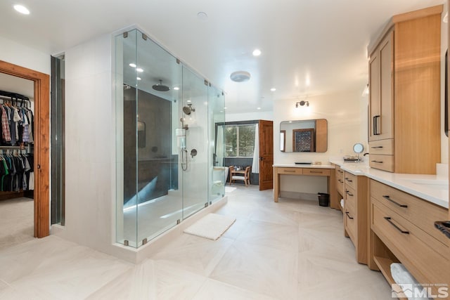 bathroom featuring vanity and a shower with shower door