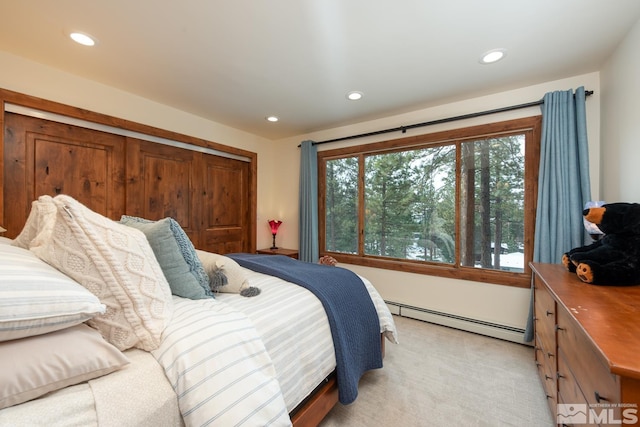 carpeted bedroom featuring a baseboard heating unit