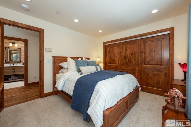 bedroom with light carpet and a closet