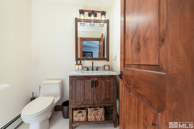 bathroom featuring tile patterned floors, toilet, vanity, and a baseboard heating unit