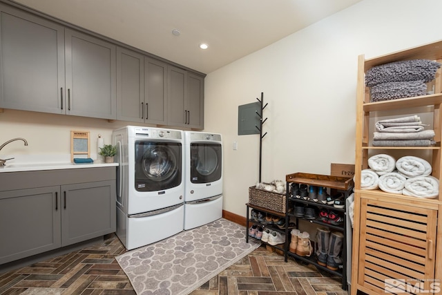 washroom with sink, cabinets, dark parquet floors, independent washer and dryer, and electric panel