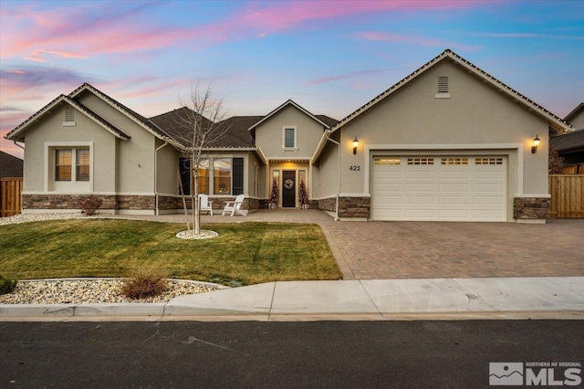 view of front of home featuring a yard and a garage