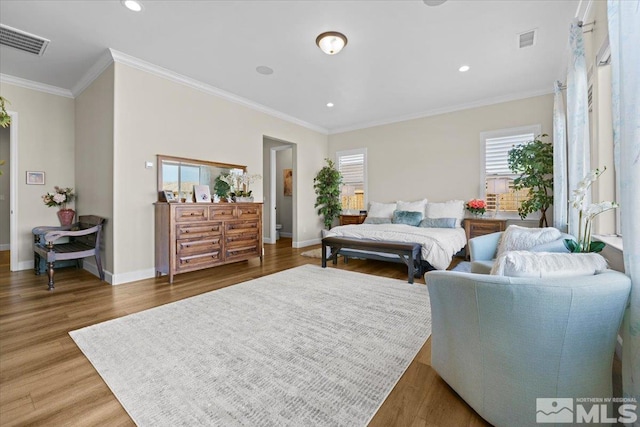 bedroom featuring hardwood / wood-style flooring and ornamental molding