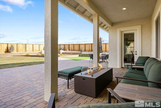 view of patio / terrace featuring an outdoor living space with a fire pit