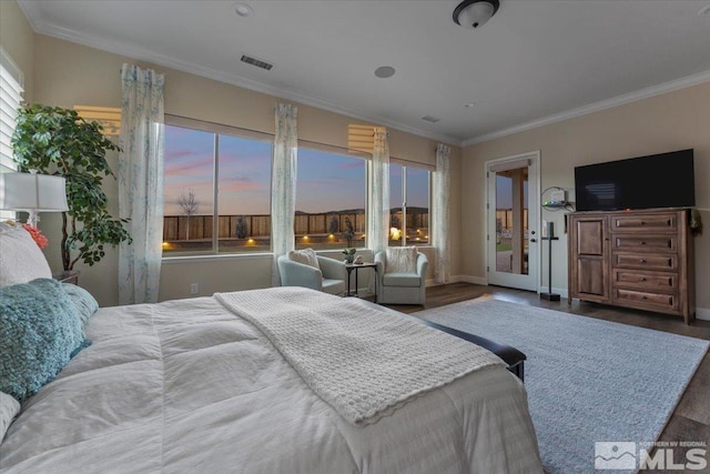 bedroom with crown molding and dark wood-type flooring