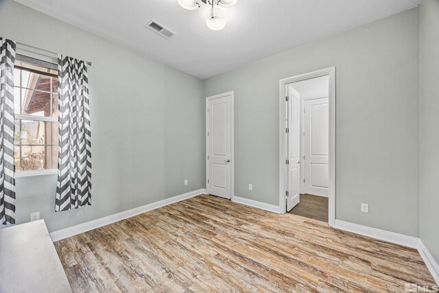 unfurnished bedroom featuring light wood-type flooring