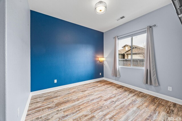 unfurnished room featuring light hardwood / wood-style flooring