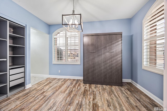 interior space with wood-type flooring and a notable chandelier