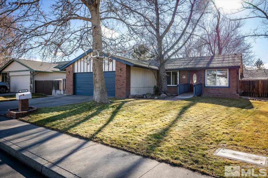 single story home featuring a front yard and a garage