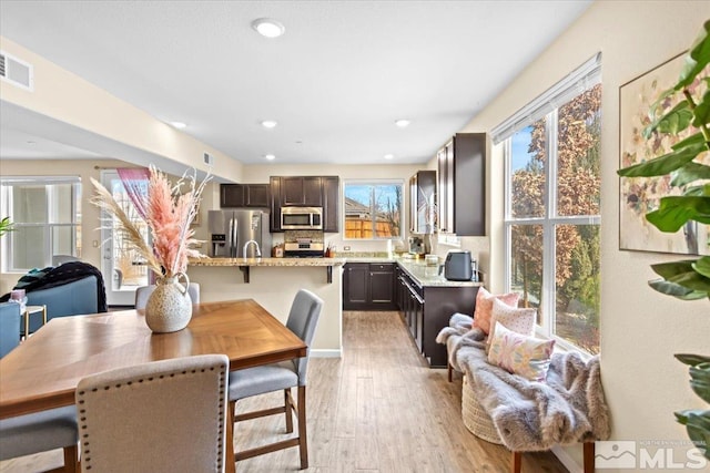 dining space with light hardwood / wood-style flooring