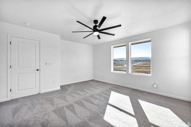 unfurnished room with light colored carpet and ceiling fan