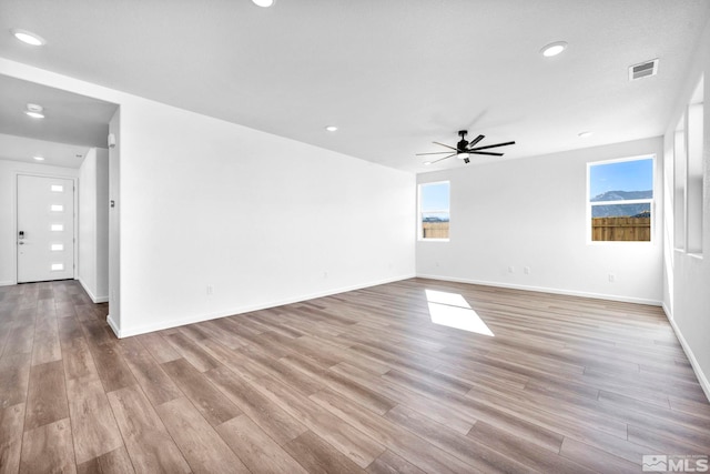 empty room featuring ceiling fan and light hardwood / wood-style floors