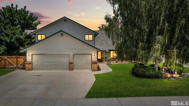 view of front of house with a garage and a yard