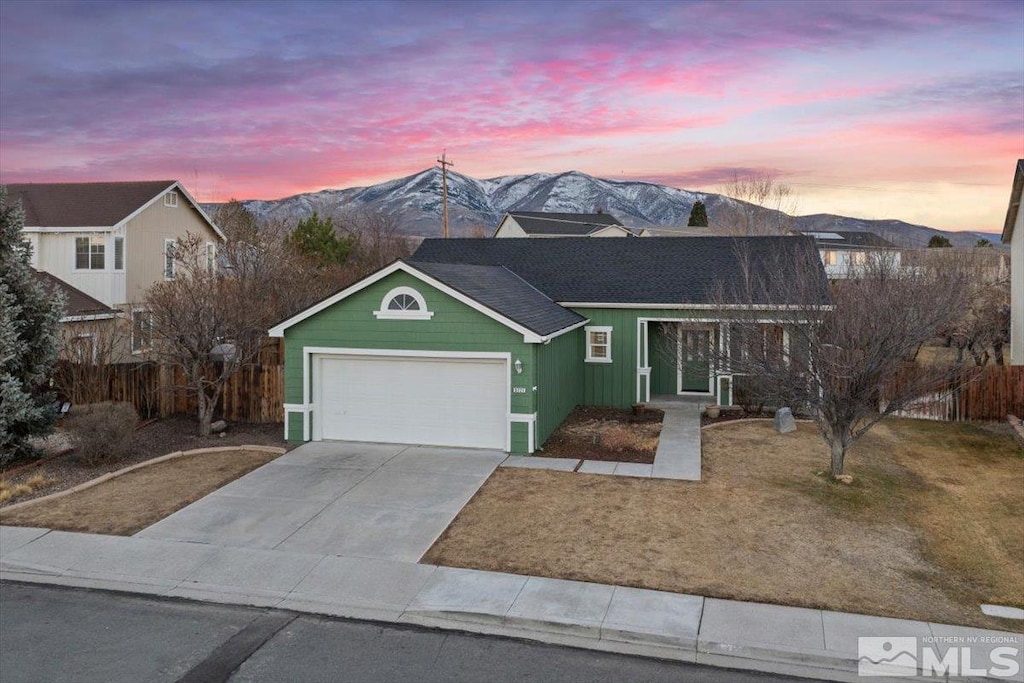 view of front of home with a mountain view and a garage