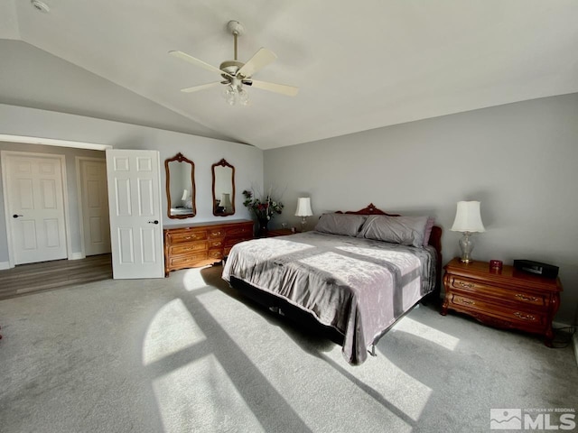 bedroom with ceiling fan, carpet, and vaulted ceiling