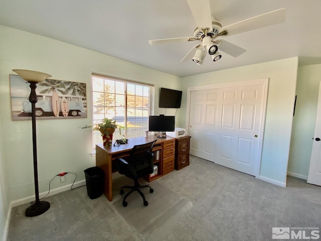 carpeted office featuring ceiling fan