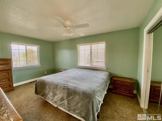 carpeted bedroom with a textured ceiling, a closet, and ceiling fan