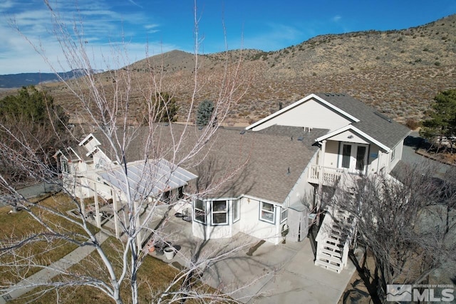 birds eye view of property featuring a mountain view