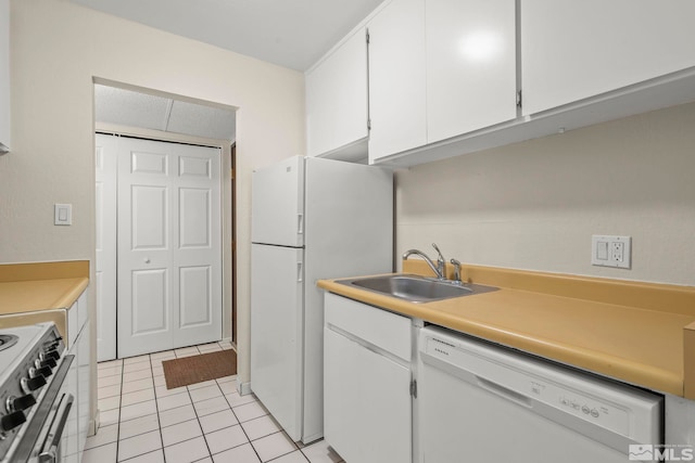 kitchen with white cabinets, light tile patterned floors, white appliances, and sink