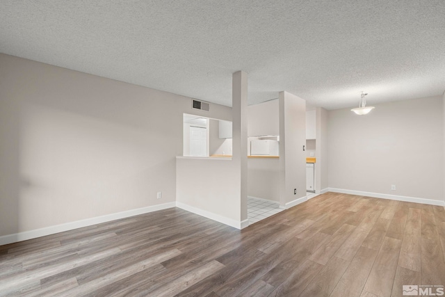 empty room featuring hardwood / wood-style floors and a textured ceiling