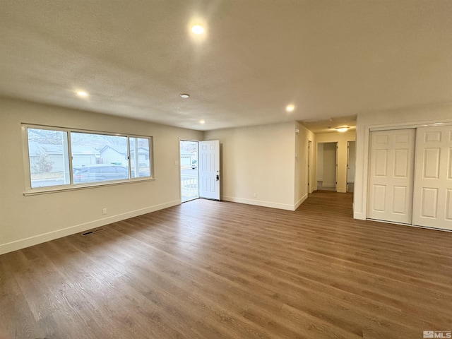 unfurnished room featuring dark wood-type flooring