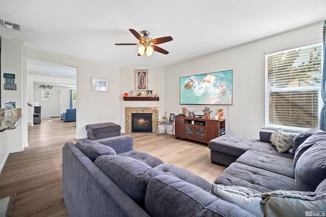 living room featuring ceiling fan and light wood-type flooring