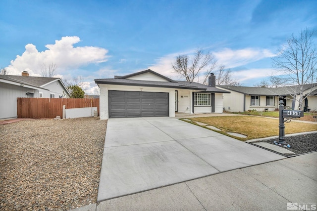 ranch-style home featuring a garage and a front lawn