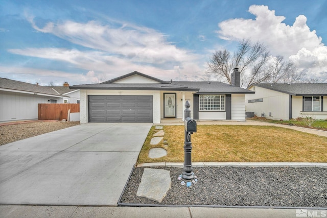 ranch-style house with a garage and a front lawn