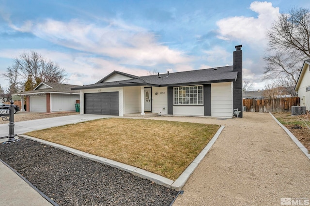 single story home with a front lawn, a garage, and central AC