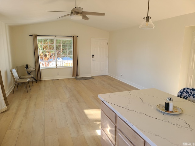 interior space featuring ceiling fan, hanging light fixtures, lofted ceiling, and light hardwood / wood-style floors