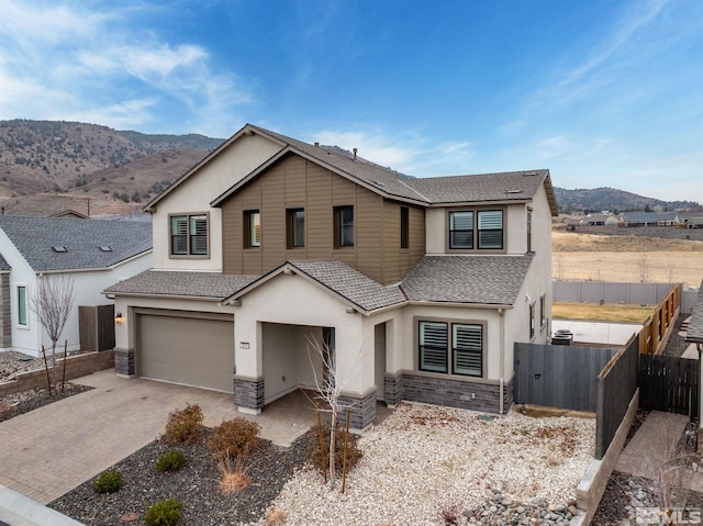 view of front of property with a mountain view and a garage